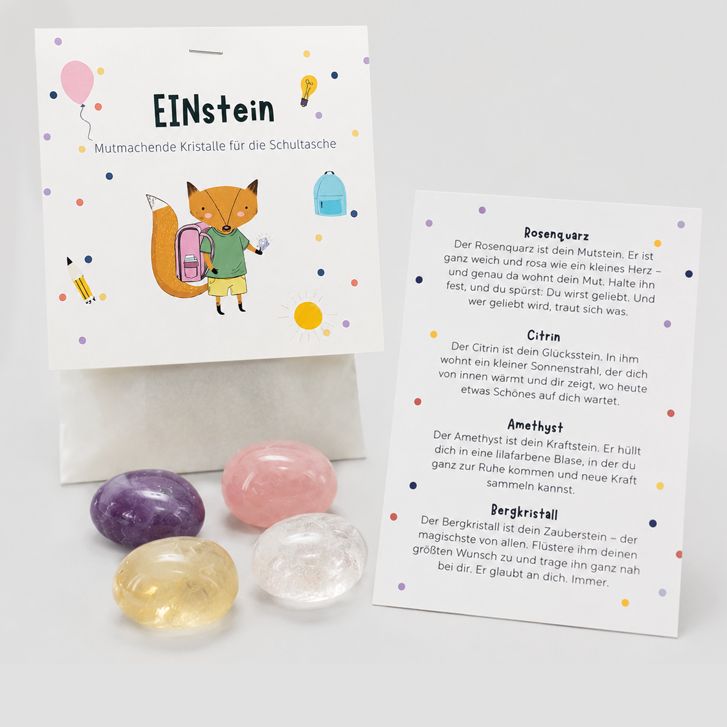 EINstein Set mit Verpackung, vier Kristallen und Kärtchen, das die Bedeutung von Rosenquarz, Citrin, Amethyst und Bergkristall erklärt