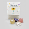 STARKmacher Set Verpackung mit Löwen-Illustration und vier bunten Kristallen davor
